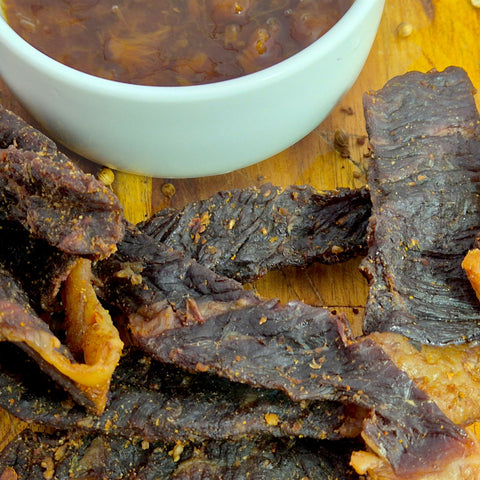 Closeup chutney biltong sticks with chutney in a small bowl